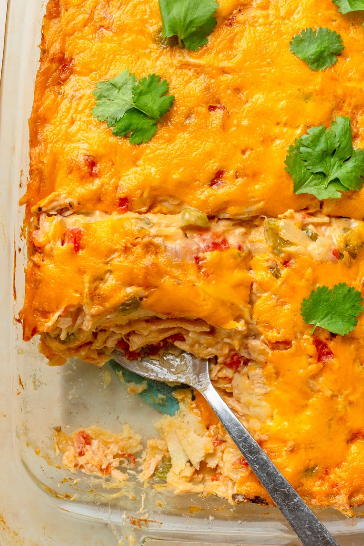 serving old-fashioned rotel chicken casserole from baking dish.