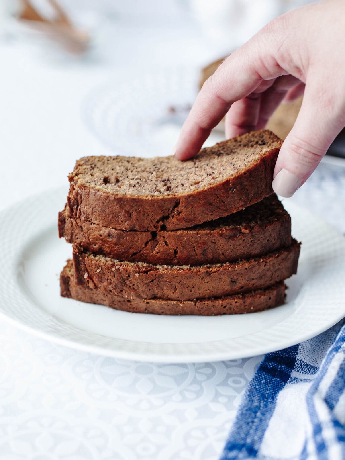 Stack of sliced banana bread with mayo showing soft texture.