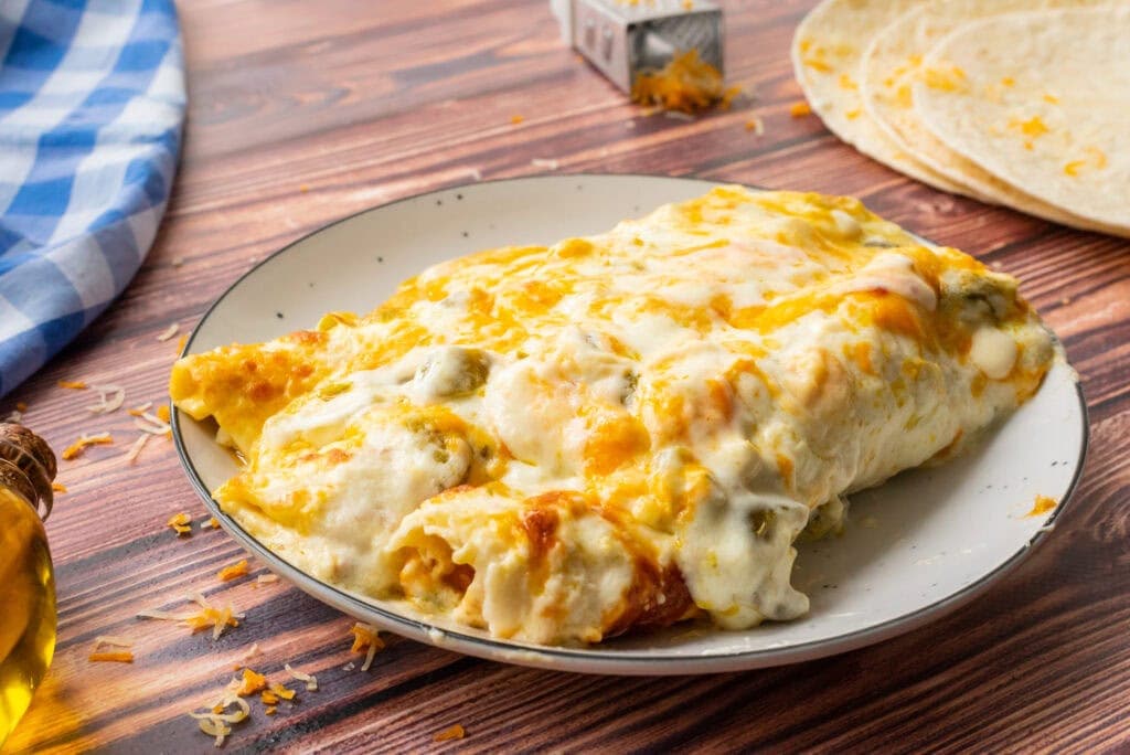 A serving of sour cream enchiladas served on a dinner plate.