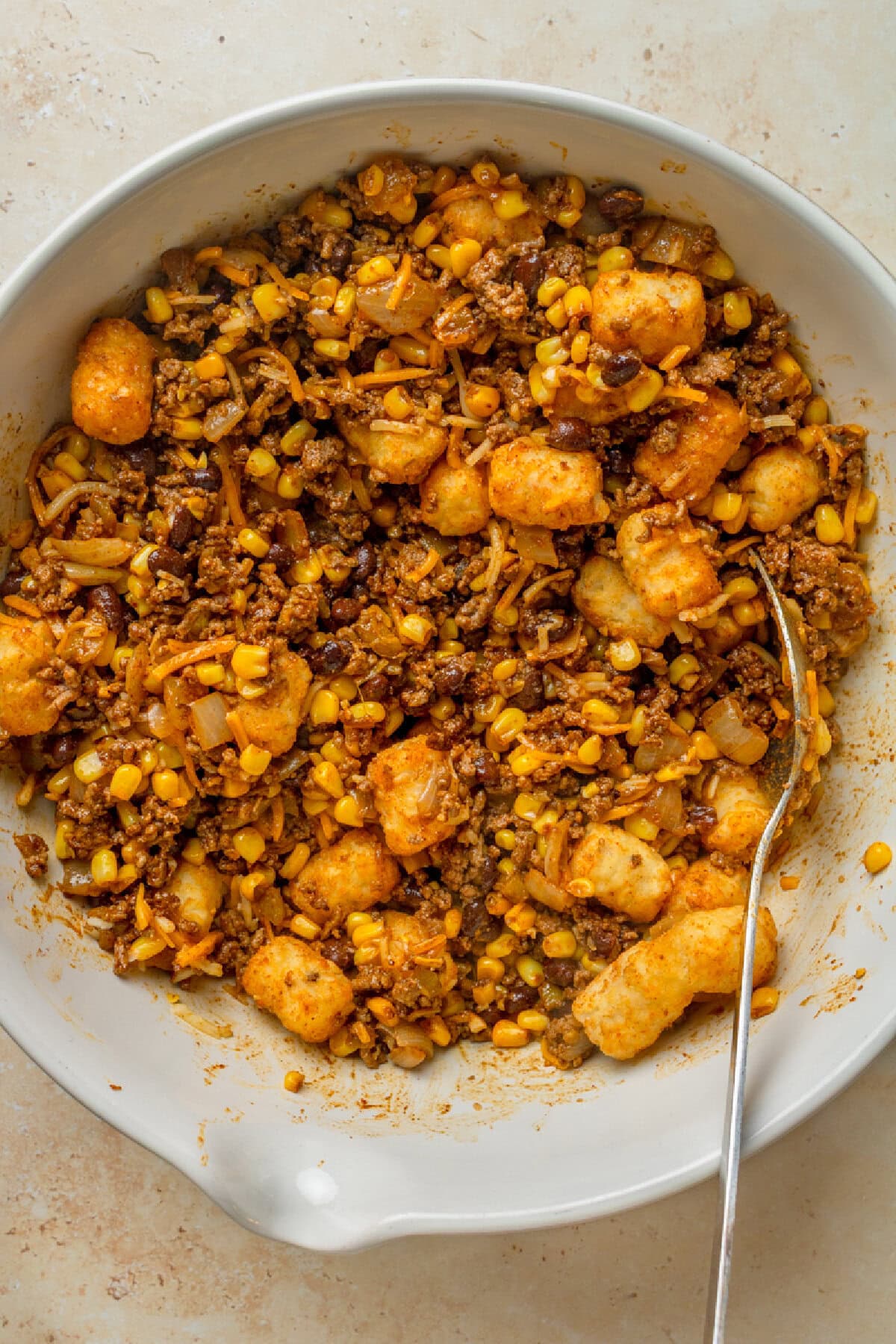 Frozen tater tots mixed with seasoned ground beef and cheese.