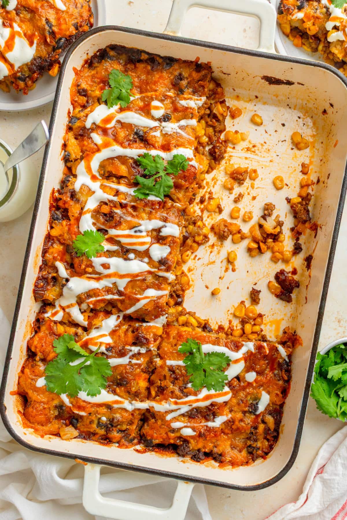 Pieces of taco tater tot casserole in a baking pan.