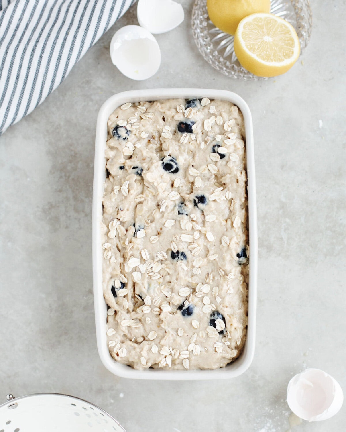 Blueberry oatmeal bread batter spread evenly into a prepared loaf pan.