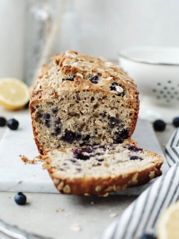 A slice of blueberry lemon oatmeal bread ready to serve.