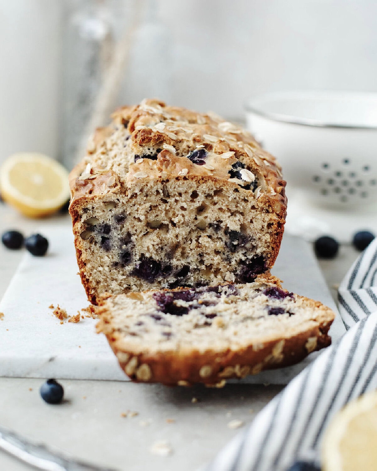 A slice of blueberry lemon oatmeal bread ready to serve.