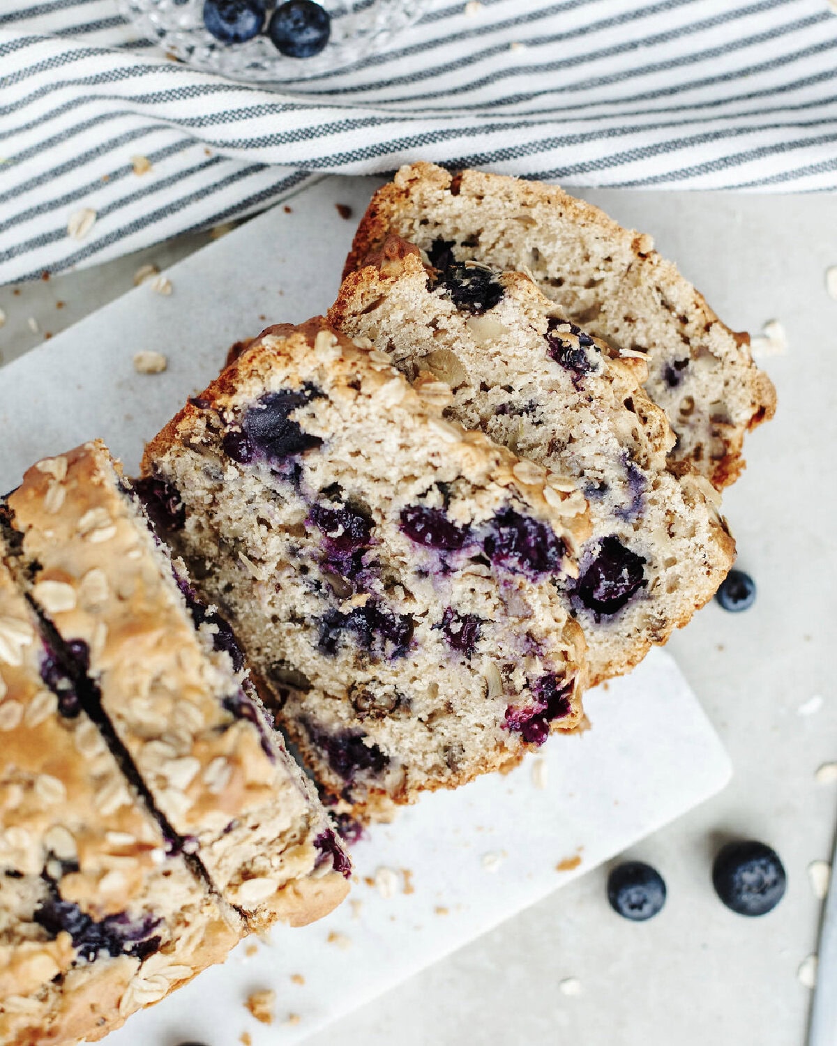 Sliced blueberry lemon oatmeal bread on a serving tray.