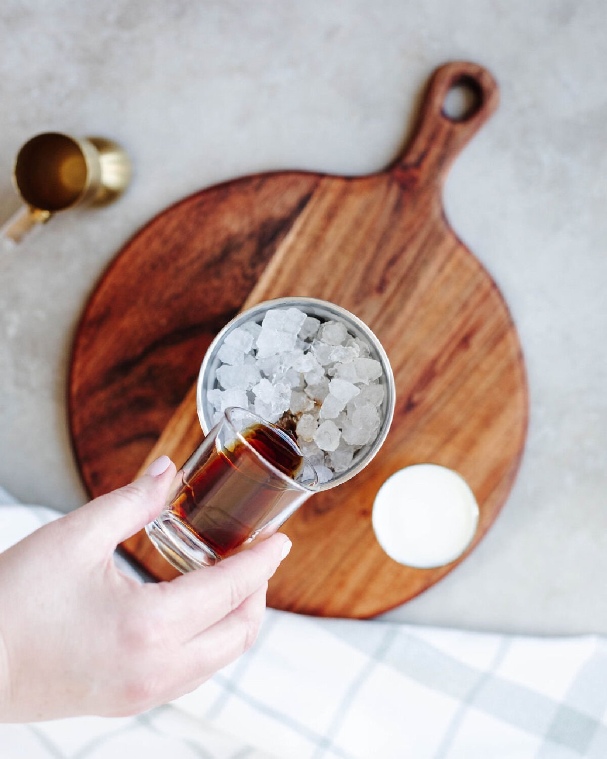 Kahlua added to a cocktail shaker with ice.