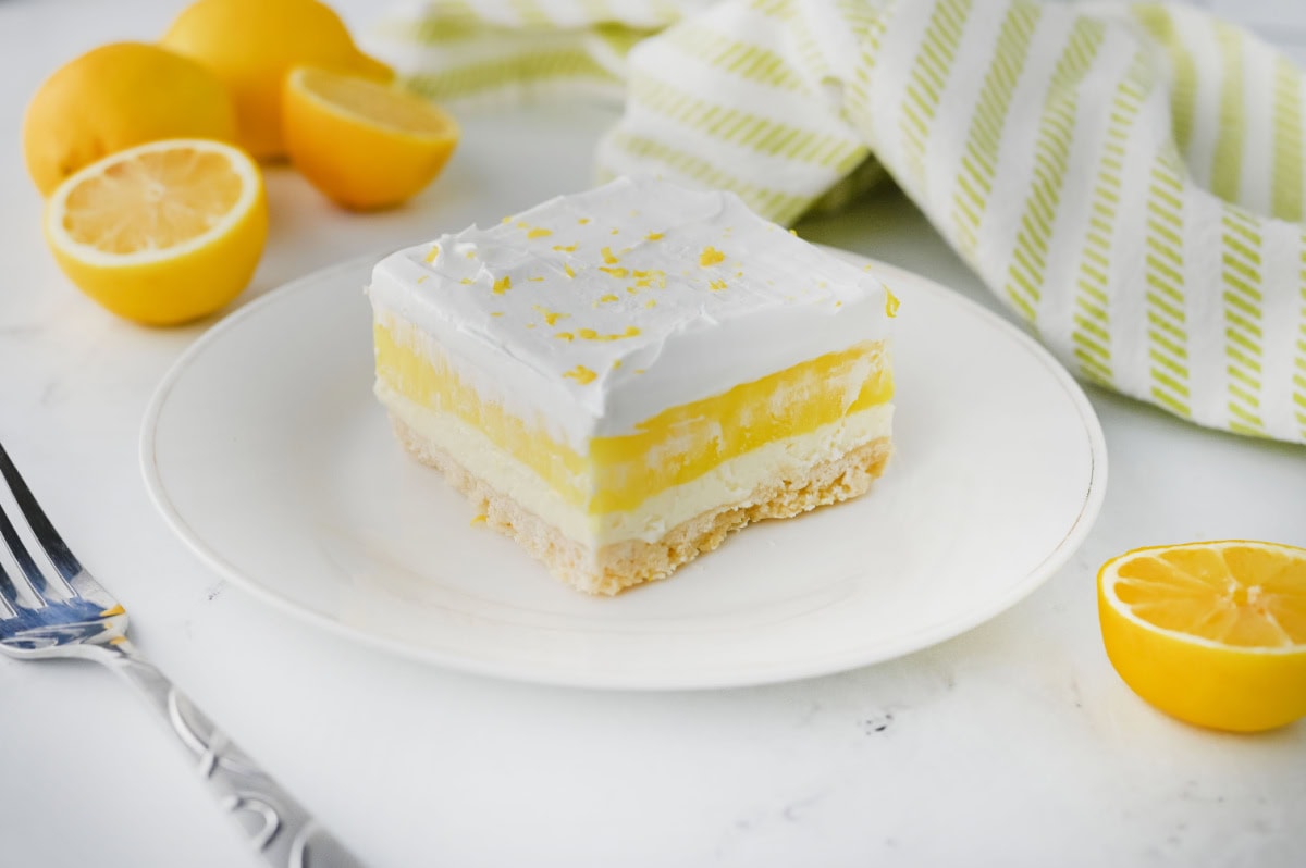 slice of lemon lush dessert showing layered filling.