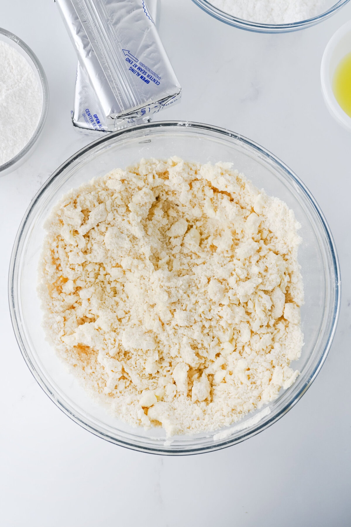 Butter cut into flour in a glass mixing bowl.