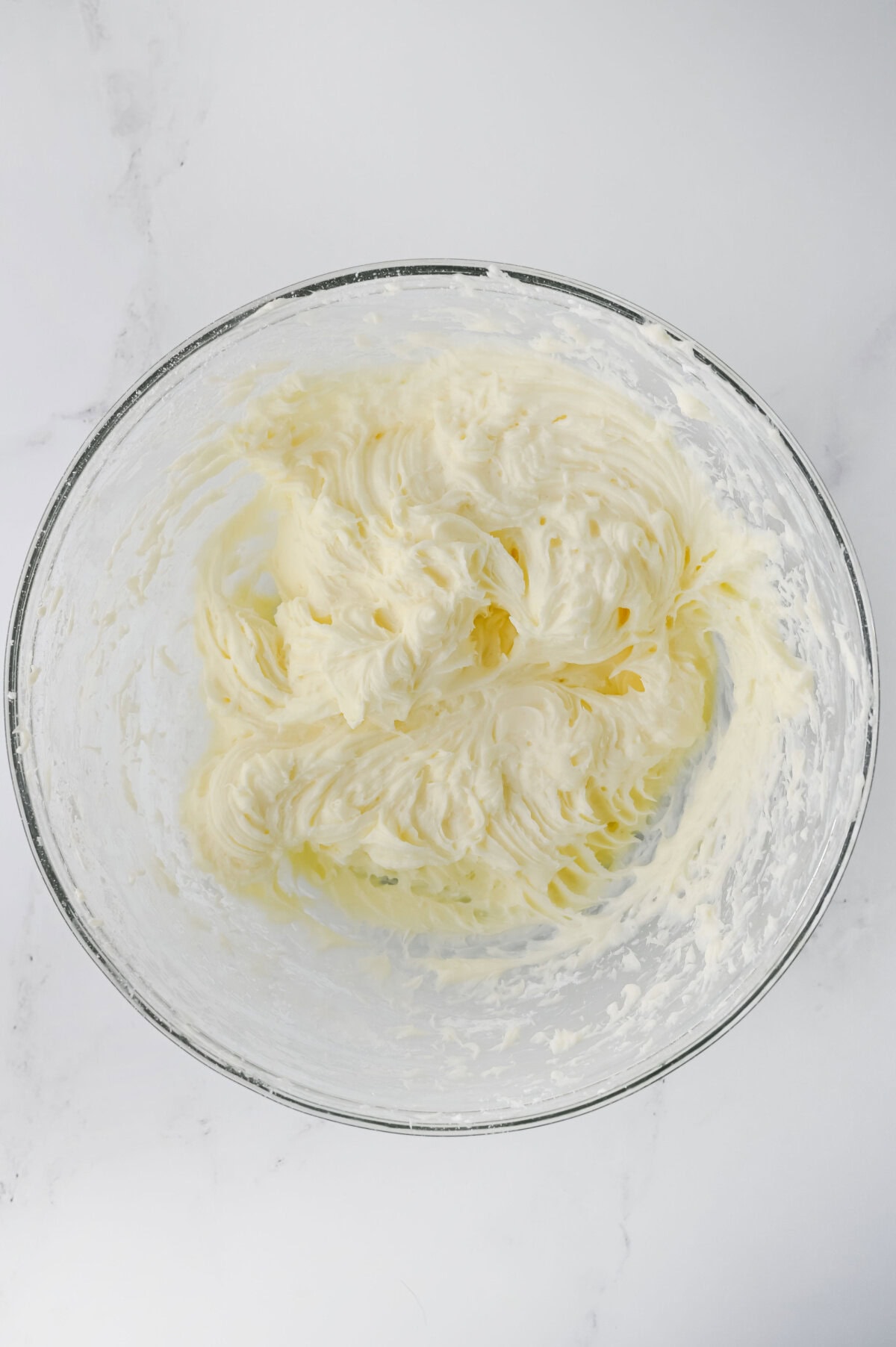 mixing cream cheese and powdered sugar for dessert layer.