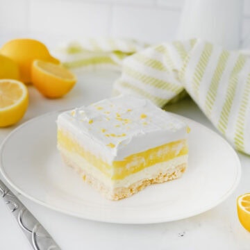 Sliced lemon lush dessert served on a white plate.