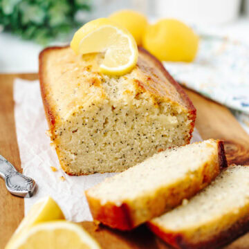 Sliced lemon bread loaf on a wood cutting board.