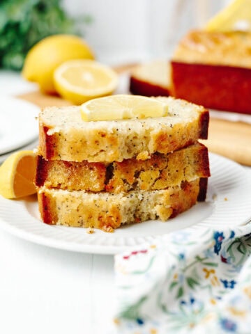 Slices of lemon bread stacked on a white plate.
