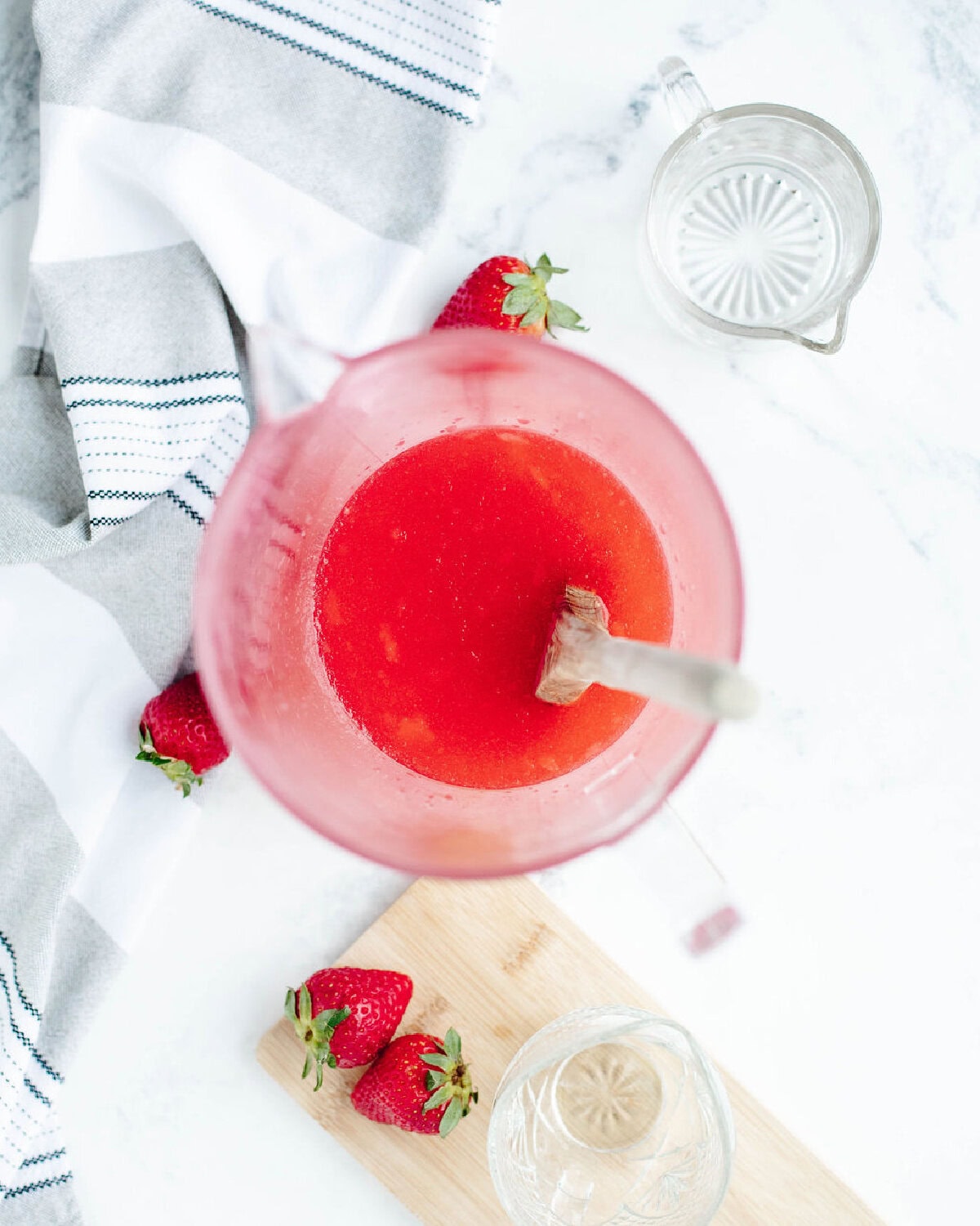 Strawberry skittles cocktail combined in a large pitcher.