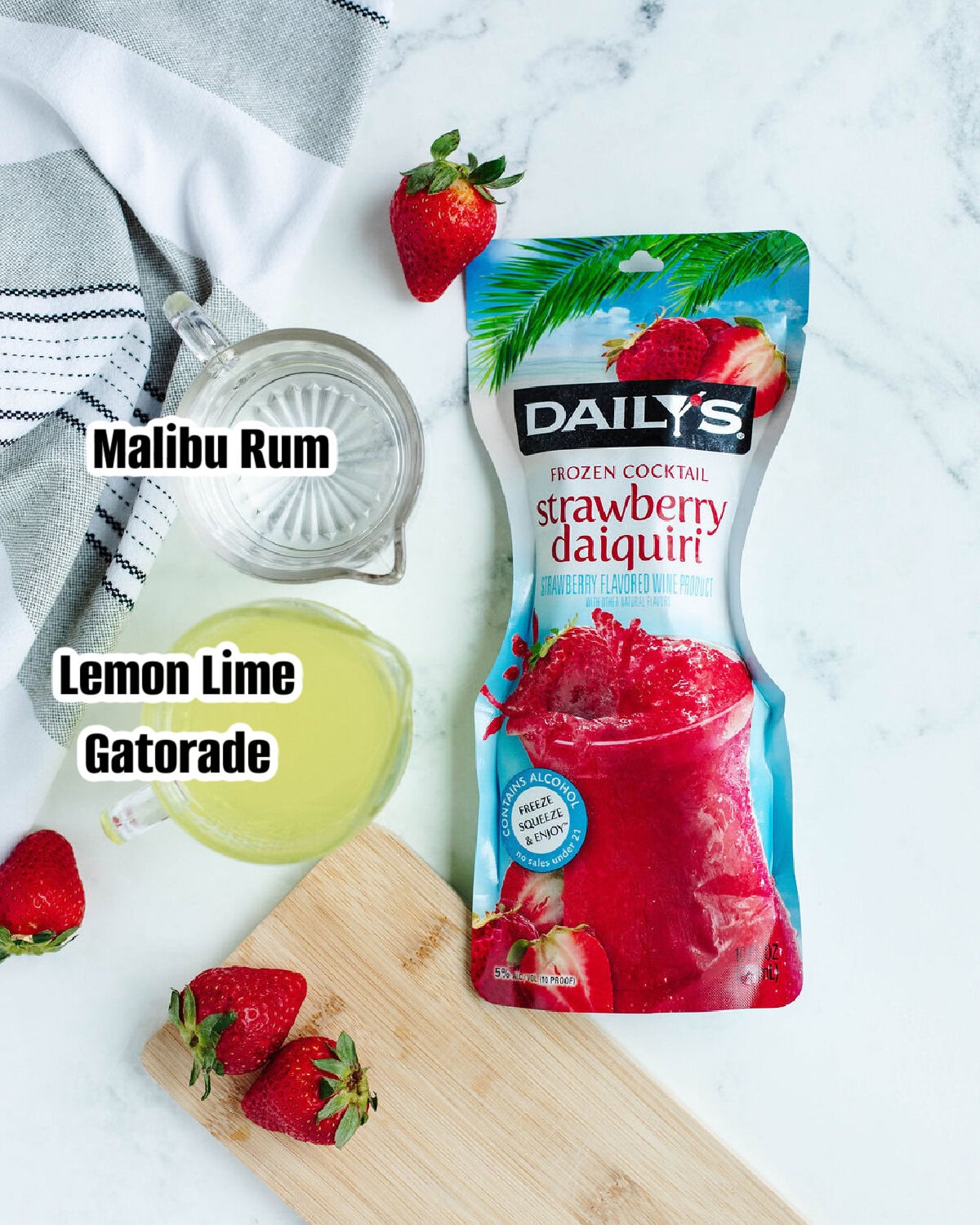 Ingredients for a Liquid Skittles cocktail including Malibu rum, strawberry daiquiri mix, and lemon-lime Gatorade.