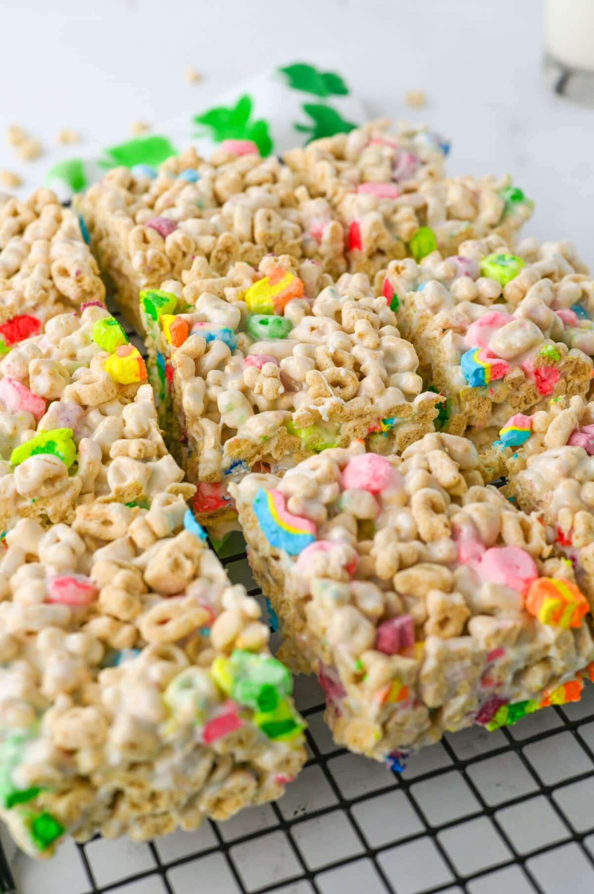 Sliced lucky charm cereal bars on a wire rack.