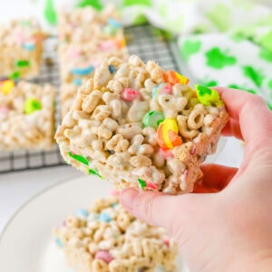 A slice of Lucky Charms cereal bars in a hand being served.
