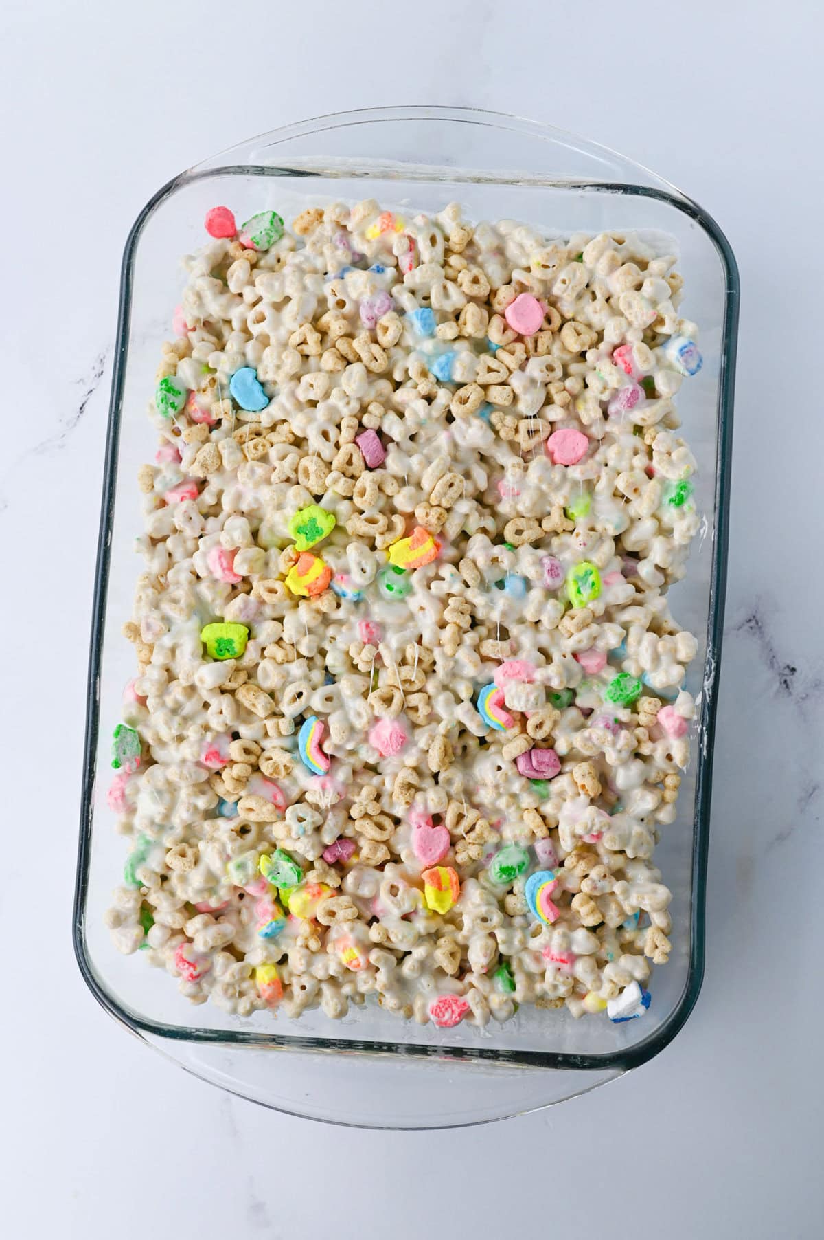 A 9x13 baking pan of marshmallow cereal bars ready to slice and serve.