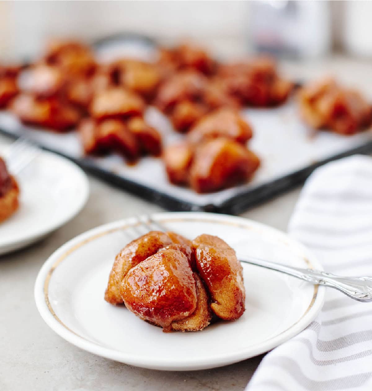 monkey bread muffins made in muffin tin with biscuits and cinnamon sugar glaze.