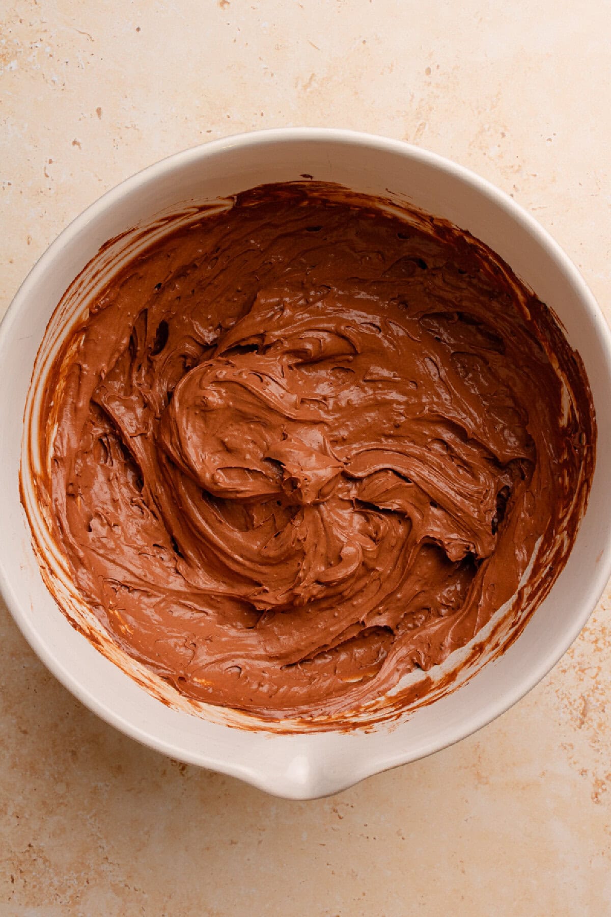 Pudding and cool whip combined in a mixing bowl.