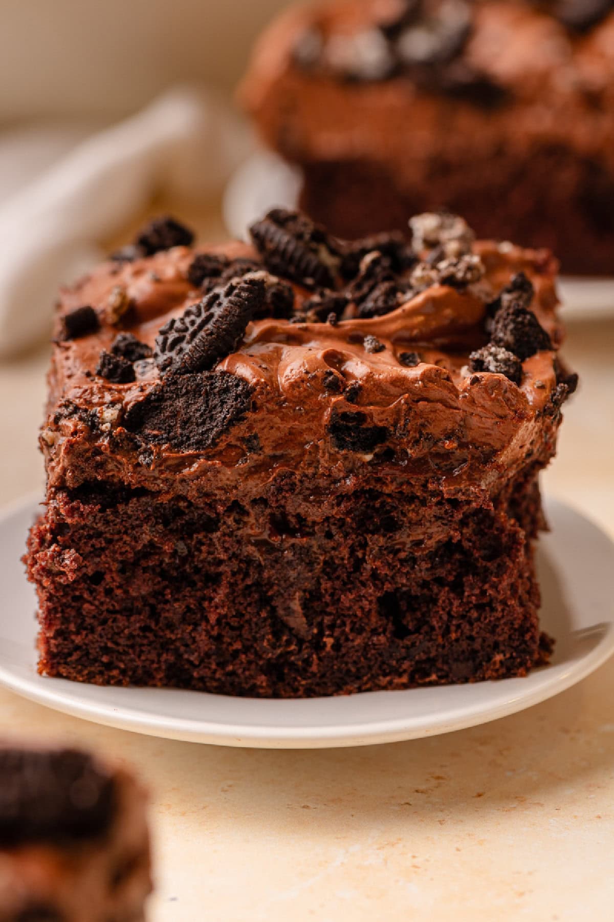 A slice of Oreo Dirt Cake on a white dessert plate.