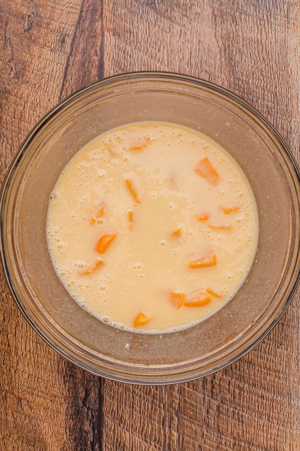 Wet ingredients combined in a glass mixing bowl.