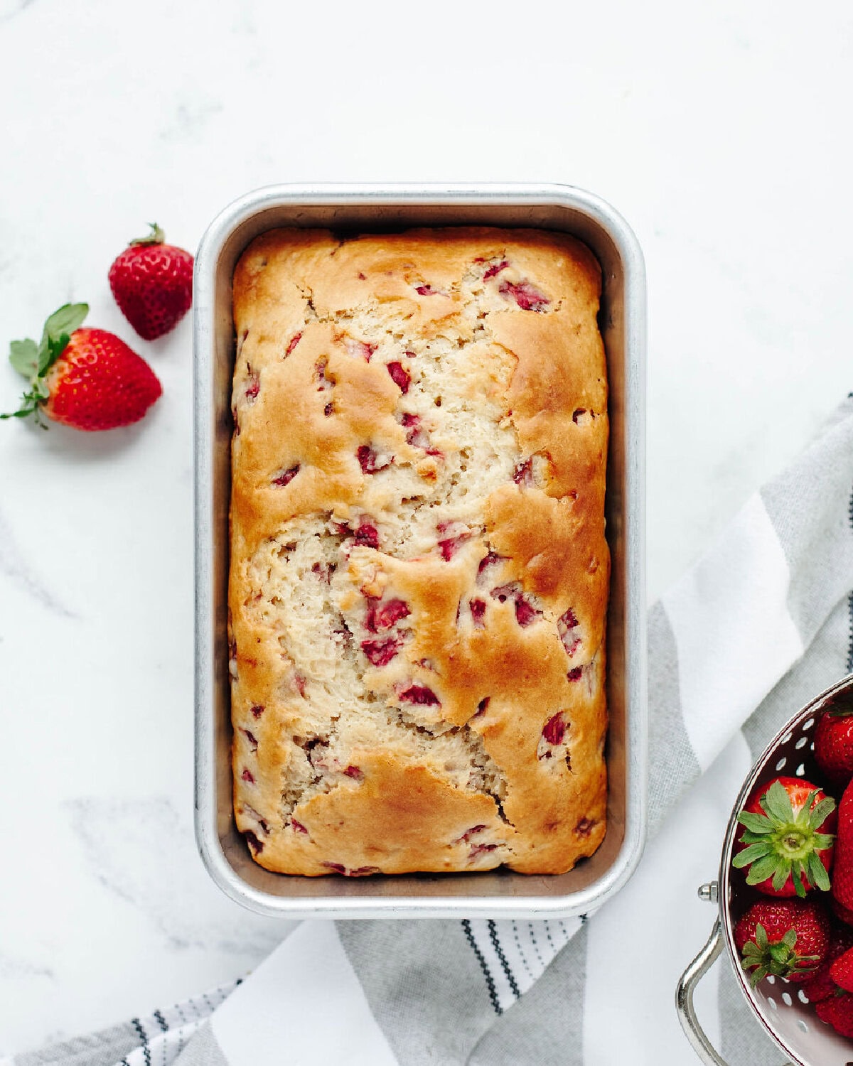 Freshly baked loaf cooling in the pan.