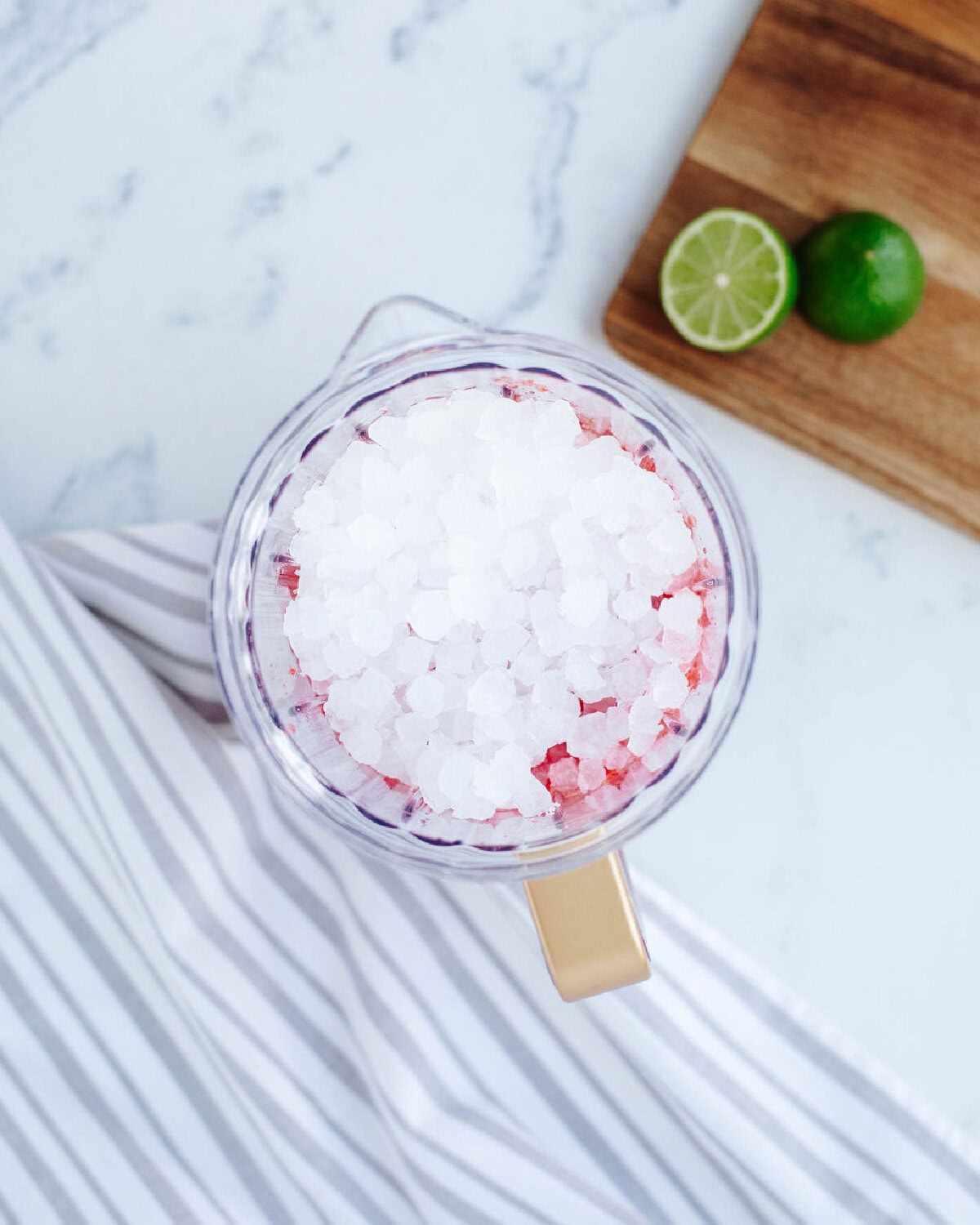 Ice cubes added to a pitcher for blending.