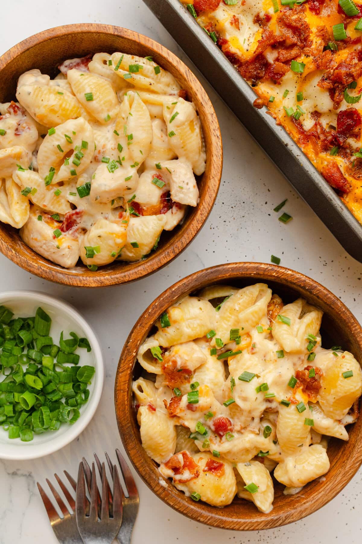Chicken Bacon Ranch Casserole served in two bowls with added green onions on top.