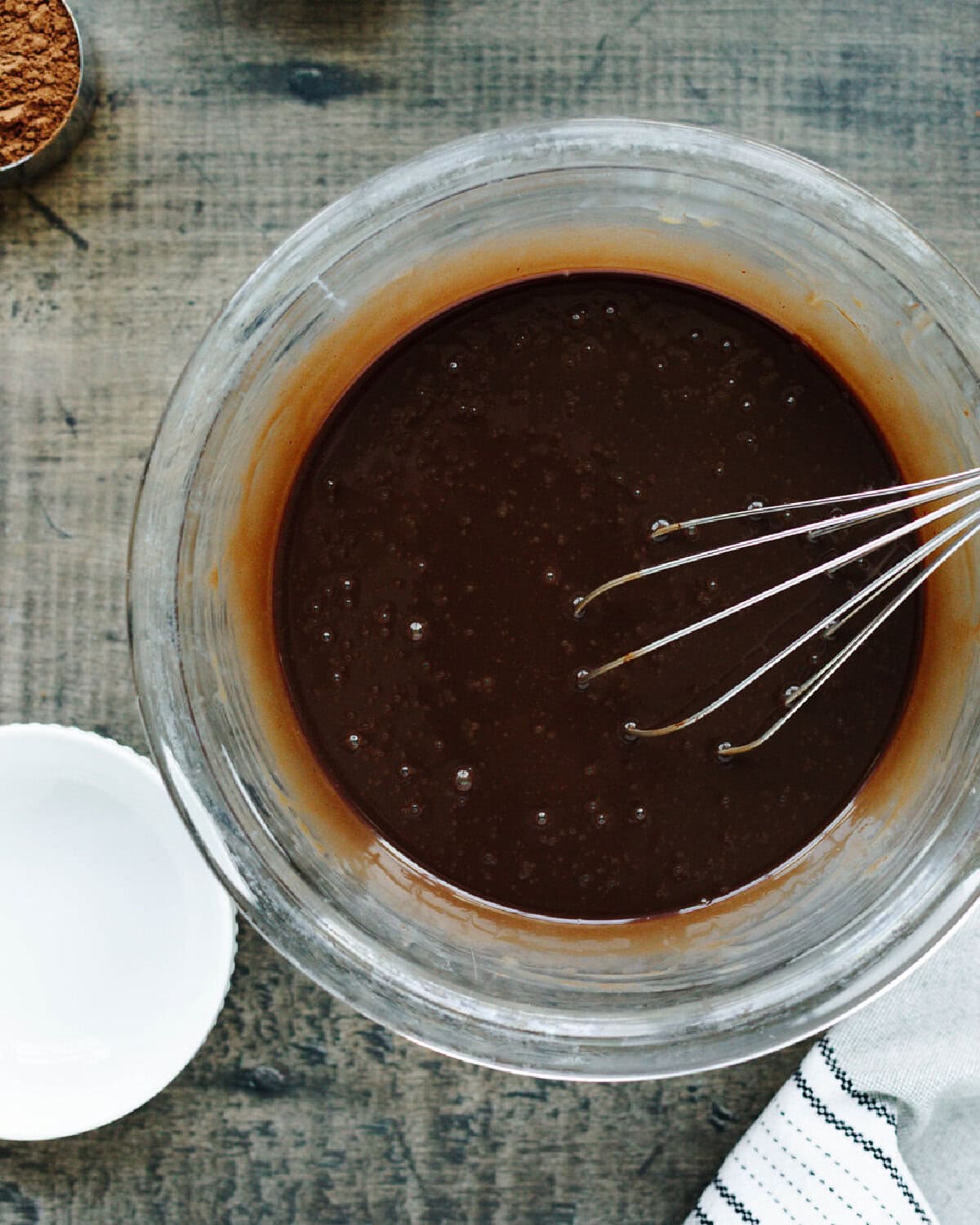 Prepared chocolate cake mix in a glass bowl.