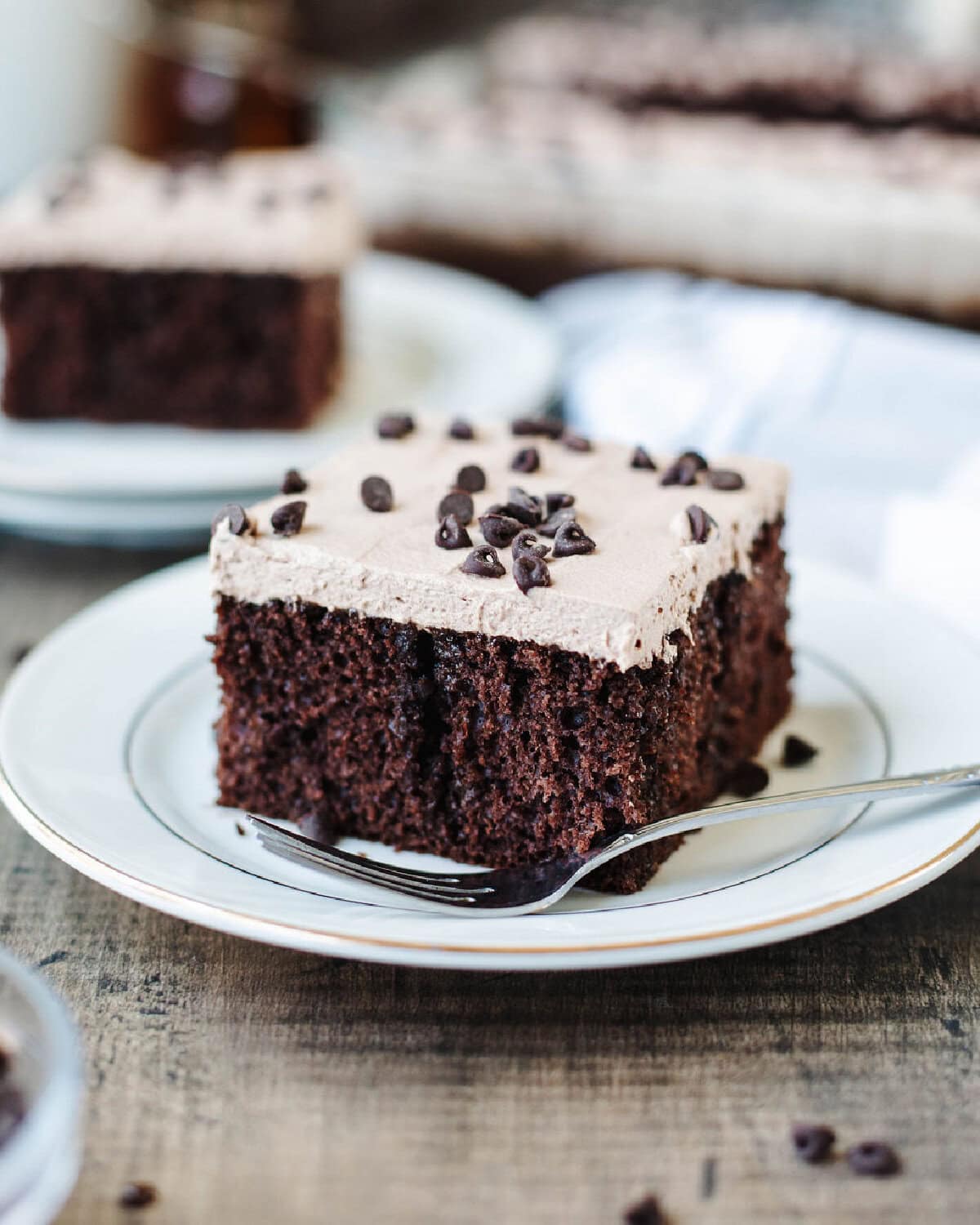 A slice of Kahlua poke cake served on a white plate with a fork.