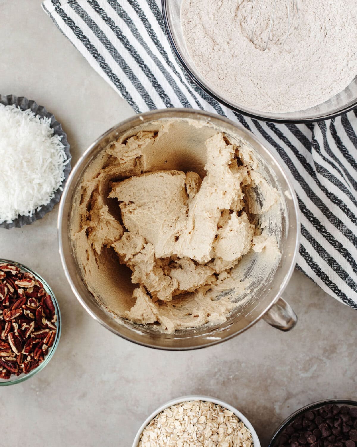 Butter, white sugar, and brown sugar creamed together in a bowl.