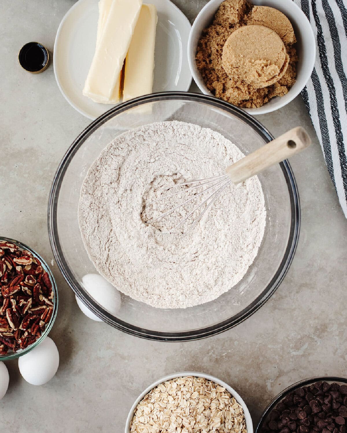 Flour, baking powder, baking soda, cinnamon, and salt combined in a glass bowl.