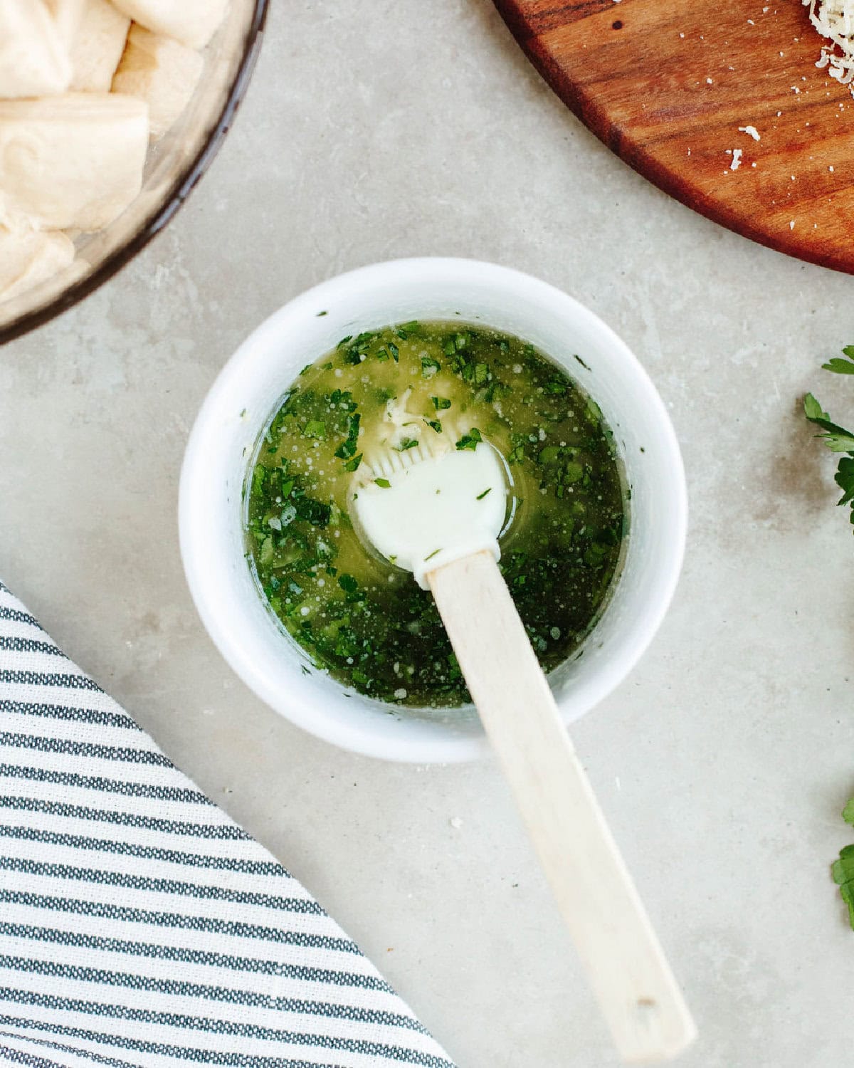 Melted butter, parsley, and garlic combined in a small bowl.
