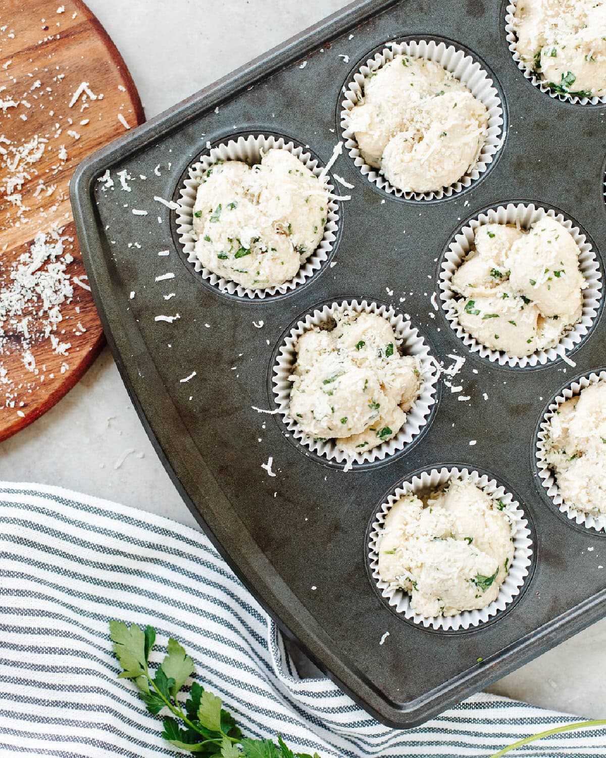 Coated biscuit pieces placed into a prepared muffin tray and ready for the oven.