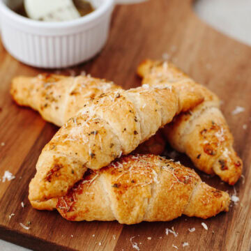 Garlic Parmesan Crescent rolls on a wood serving board ready to enjoy.