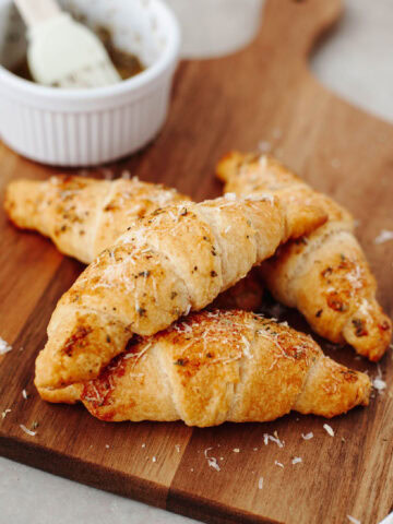 Garlic Parmesan Crescent rolls on a wood serving board ready to enjoy.