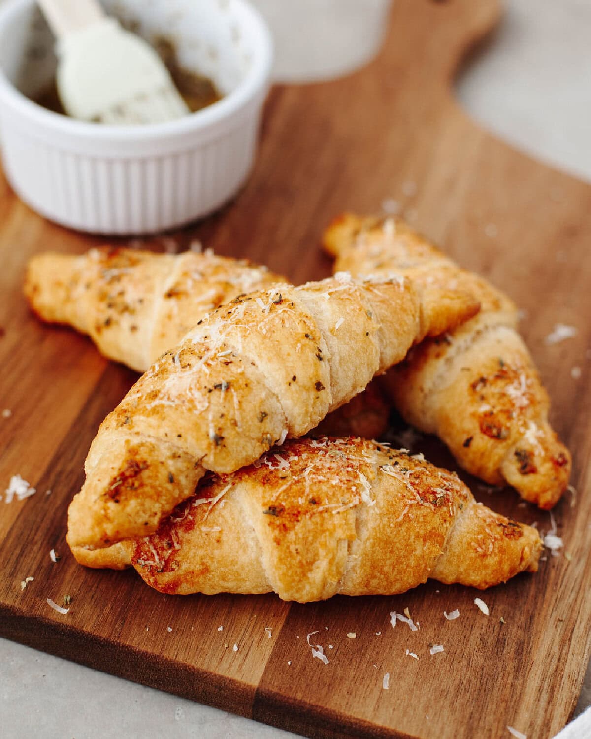 Garlic Parmesan Crescent rolls on a wood serving board ready to enjoy.