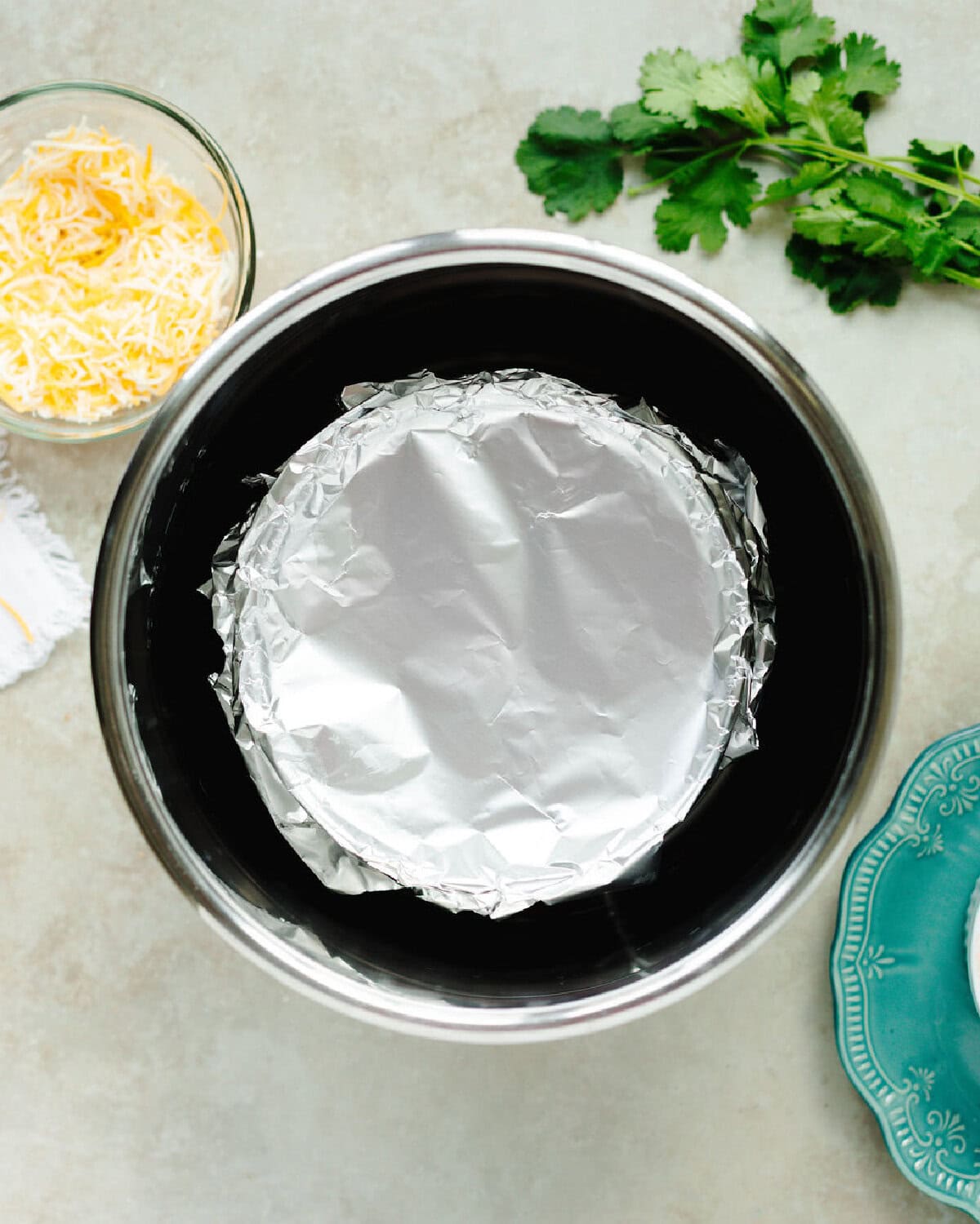 Foil covering a Mexican casserole in the instant pot.