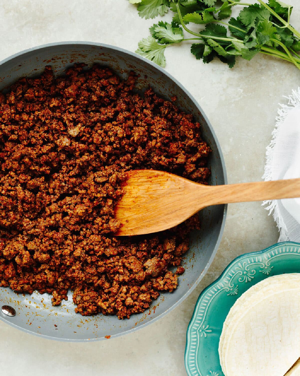 Ground beef cooked and seasoned in a skillet.