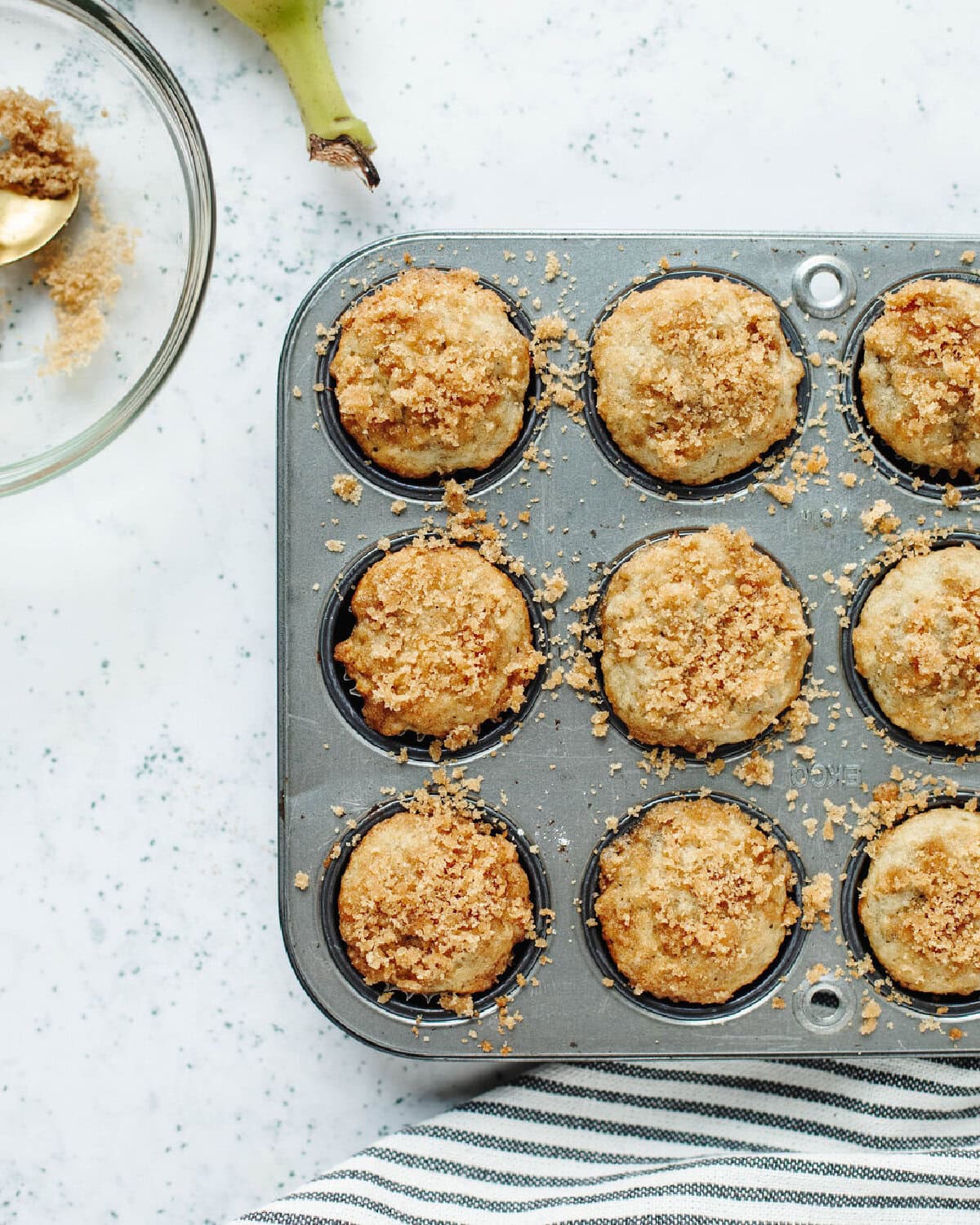 Baked cinnamon banana mini muffins in a muffin pan.