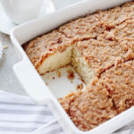 Baked morning cake with a slice removed from a baking pan.