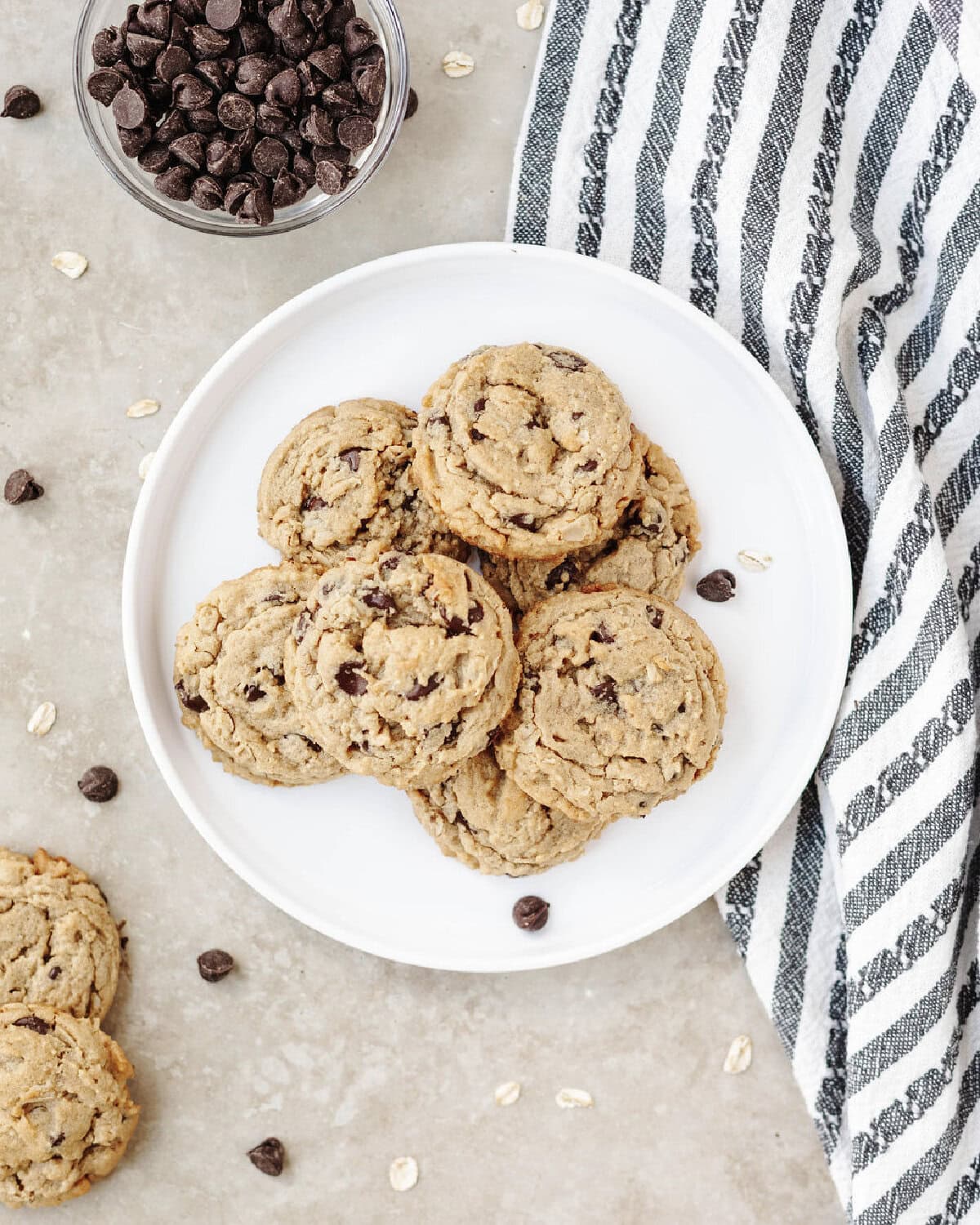 Baked peanut butter oatmeal chocolate chip cookies on a white plate.