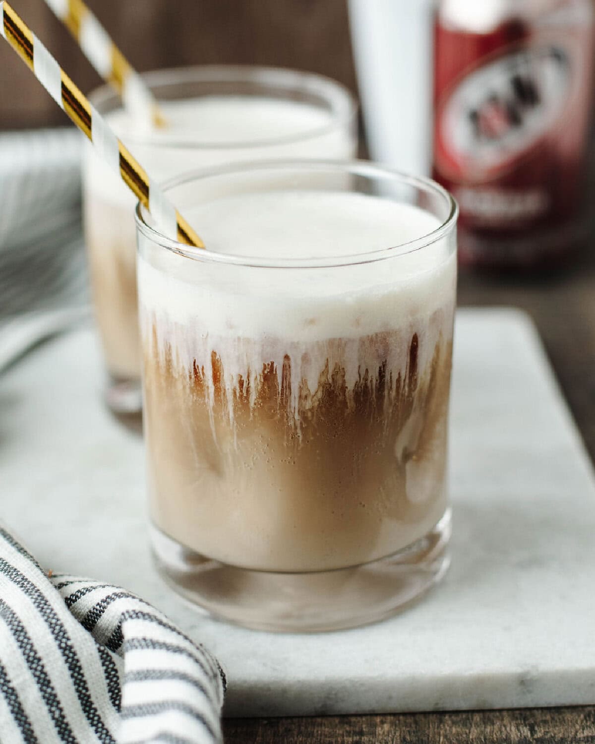 Close up of a frothy root beer drink.