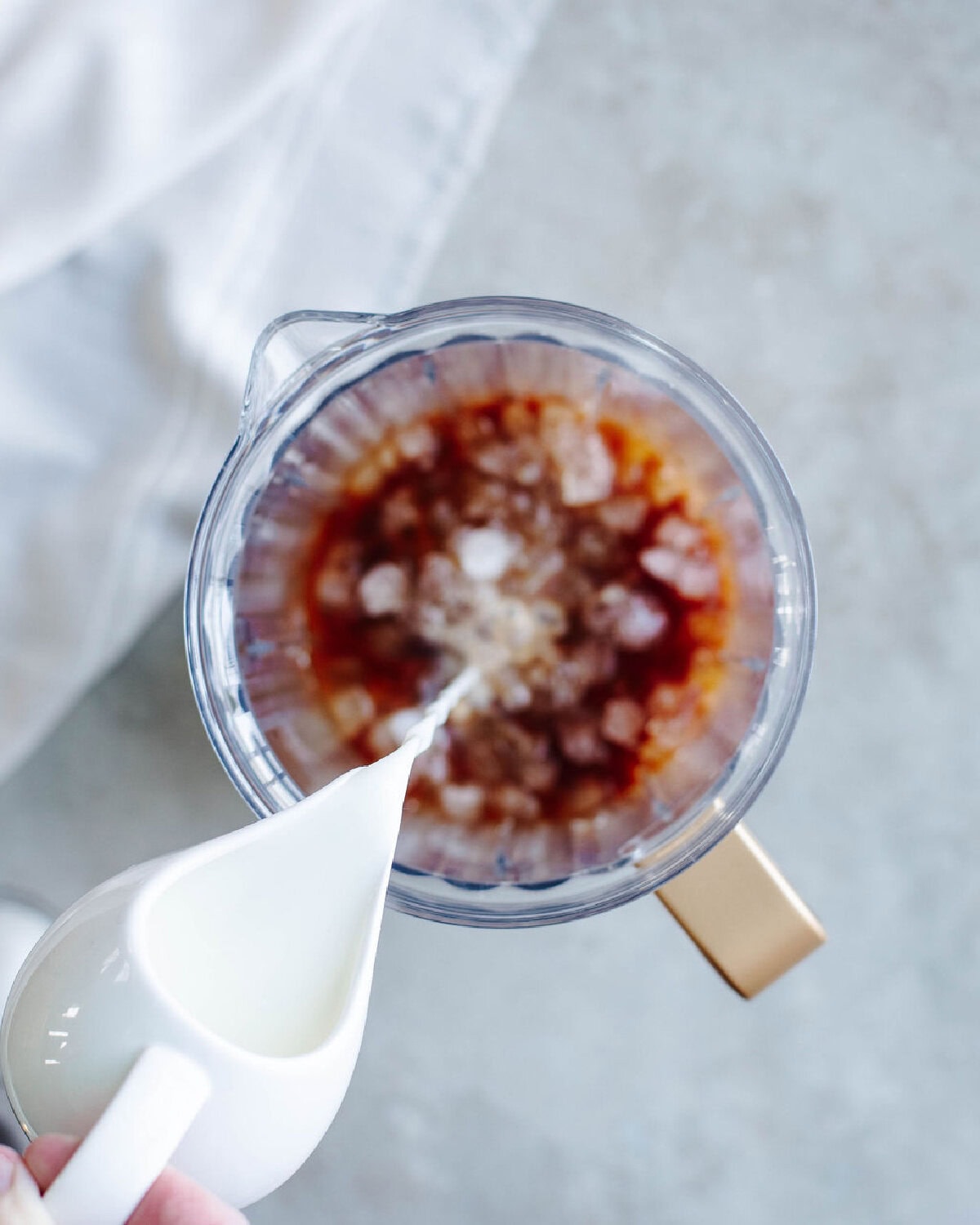 Milk added to a blender pitcher.