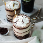Whipped cream and chocolate sprinkles on top of two glasses of Baileys Frappuccino.