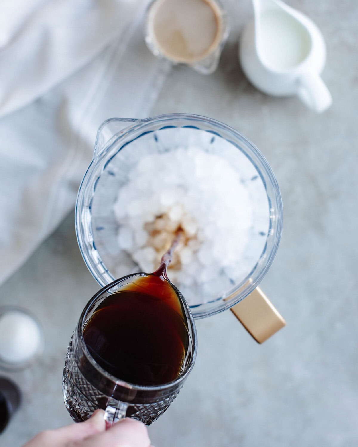 Brewed coffee poured over ice in a blender.