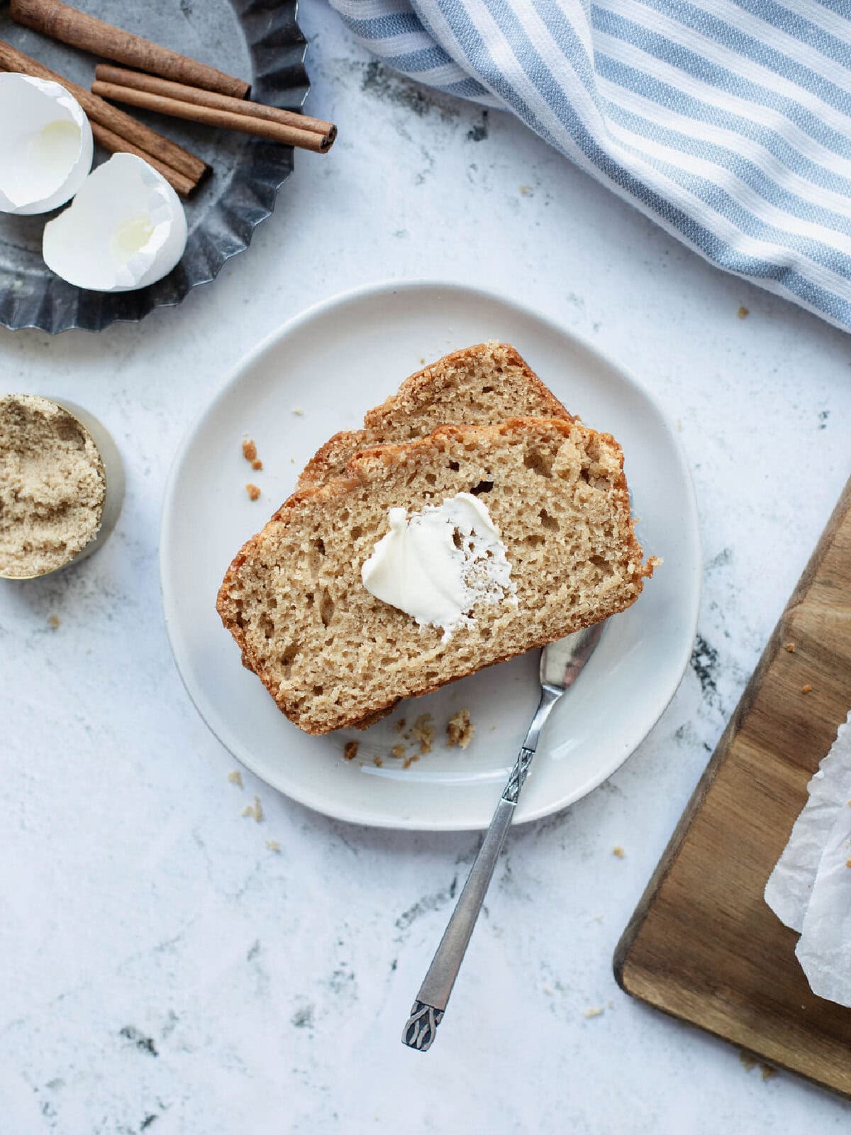 Butter spread onto a thick slice of homemade bread.