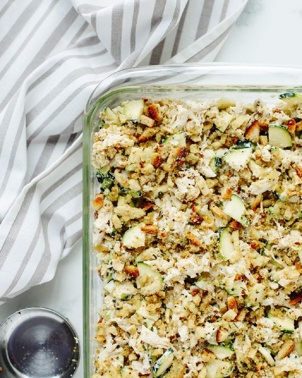 Stuffing on top of zucchini casserole ready for the oven.