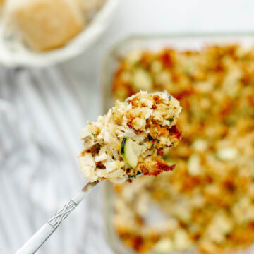 A spoon serving a scoop of chicken zucchini casserole.