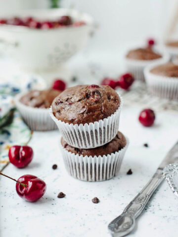 Stacked chocolate cherry muffins ready to serve.
